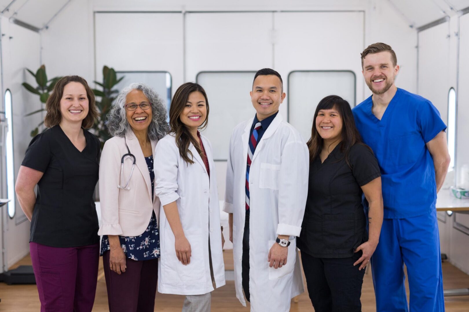 Medical team smiling in a clinical setting.