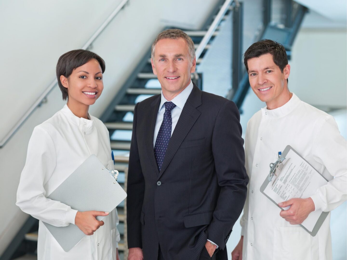 Businessman with two smiling healthcare professionals.