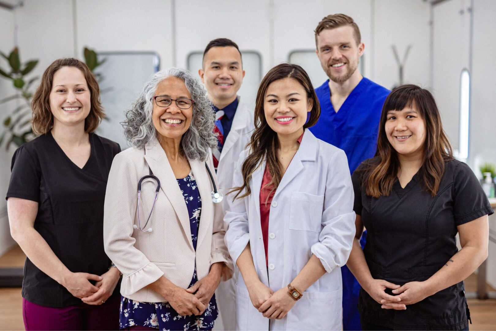 Healthcare professionals smiling in a group portrait.