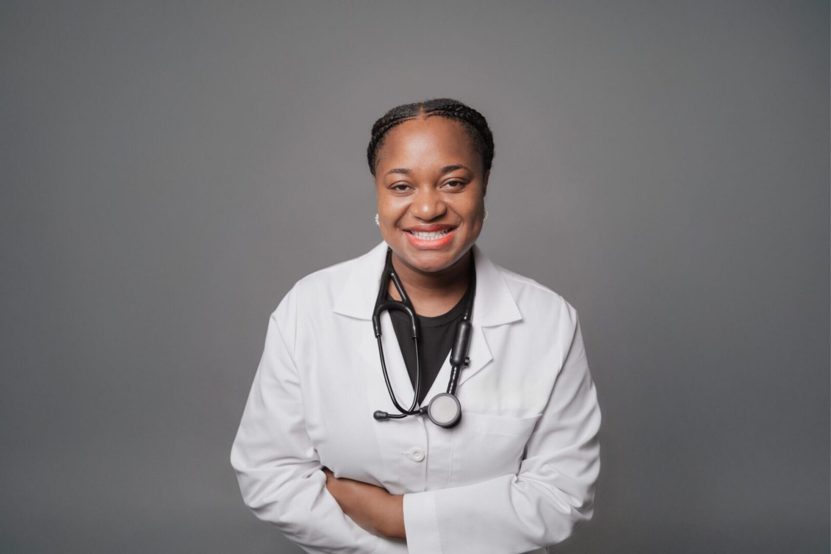 Smiling doctor with stethoscope and lab coat.