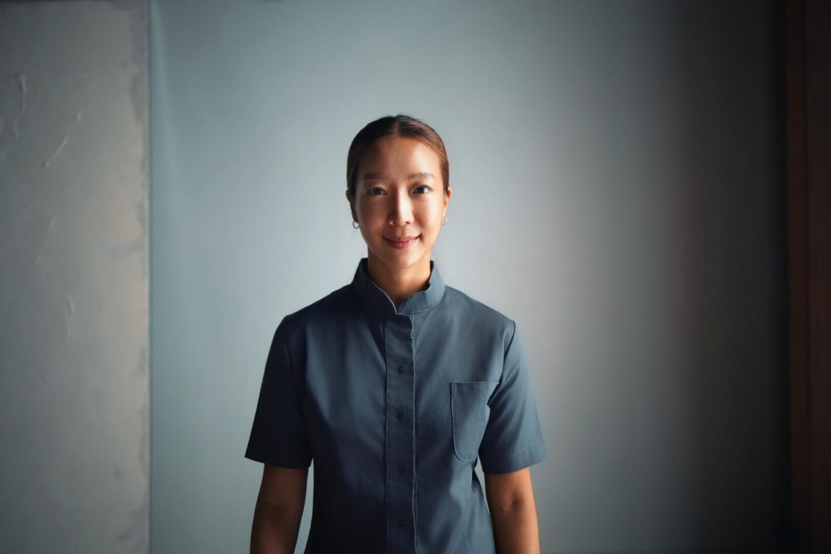 Smiling person in a dark blue shirt.