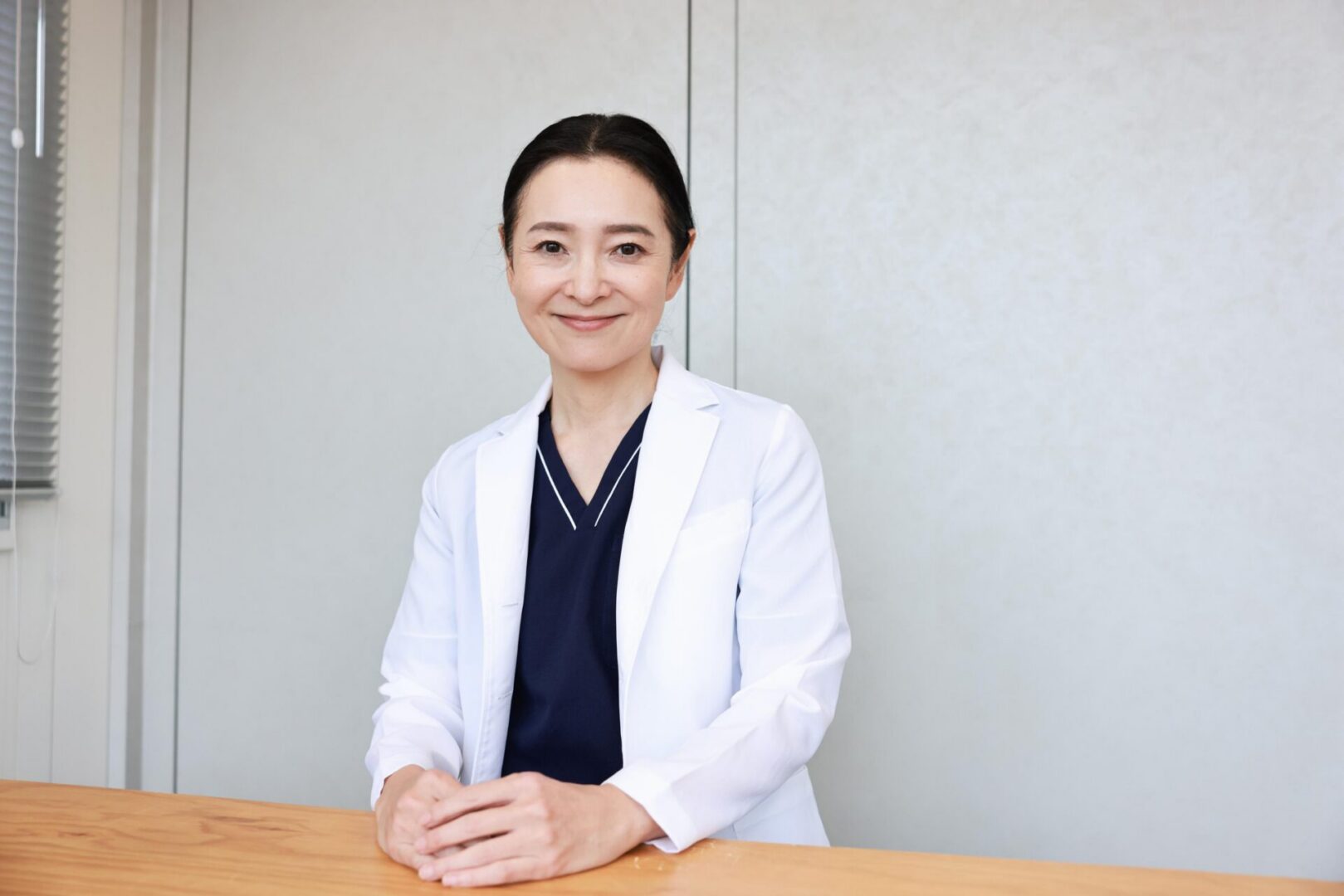 Cheerful woman wearing a white coat